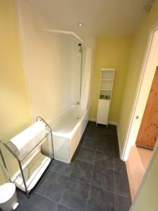 a small bathroom with a tub and a shower at Magnolia Cottage in Launceston