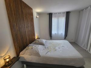 a bedroom with a bed and a window at Gîtes A Gravona in Ajaccio