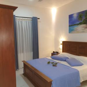 A bed or beds in a room at Villa Talpe