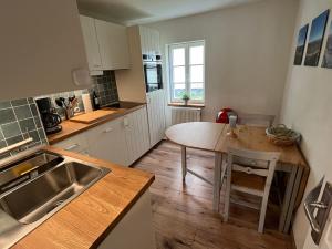 a kitchen with a wooden table and a wooden floor at Apartment 001 Kassel Harleshausen in Kassel