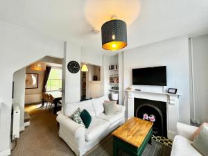 a living room with a white couch and a fireplace at 14 Union Road in Lincolnshire