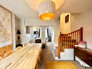 a dining room with a wooden table and a chandelier at 14 Union Road in Lincolnshire