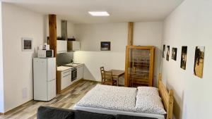 a living room with a couch and a kitchen at Apartmány Statek Bezdědice in Hostomice