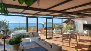 a living room with a view of the ocean at B&B Sottocoperta in Taormina