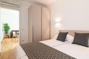 a bedroom with two white beds and a closet at Superior Beach Aparthotel in Lido di Jesolo