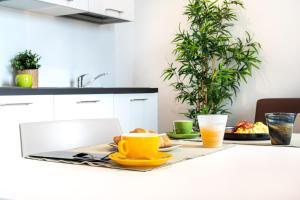 a table with a plate of food and two glasses of orange juice at Superior Beach Aparthotel in Lido di Jesolo