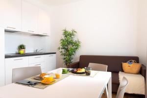 a kitchen with a table with a plate of food on it at Superior Beach Aparthotel in Lido di Jesolo