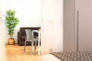 a bedroom with a table and a chair and a bed at Superior Beach Aparthotel in Lido di Jesolo