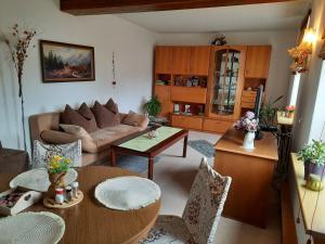 a living room with a couch and a table at Ferienwohnung Hellriegel in Weißwasser