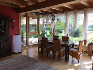a dining room with a table and chairs and a window at Wein-Chalet W141 in Weinburg am Saßbach