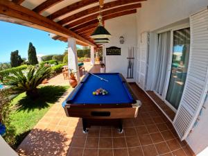 a pool table on the patio of a house at VILLA BINISABEL NOU, CONFORT Y EXCLUSIVIDAD in Sant Lluis