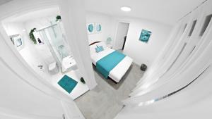 a white bedroom with a bed and a mirror at Vujicic Accommodation in Herceg-Novi