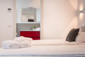 a bedroom with a bed with white towels on it at Superior Beach Aparthotel in Lido di Jesolo