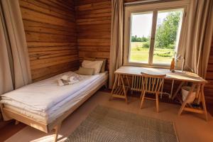 Un pat sau paturi într-o cameră la Olo Center by Kolovesi Nature Park