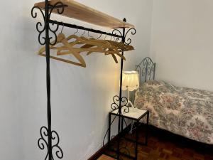 a bedroom with a bed and a table with a lamp at Casa Às Seis in Angra do Heroísmo