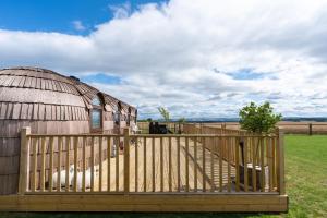 a yurt with a wooden fence in front of it at "Lammermuir" Rock & Castle Escapes in Whitekirk