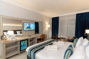 a hotel room with a bed and a television at Nishan Hotel in Amman