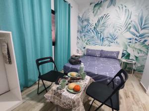 ein Zimmer mit einem Bett und einem Tisch mit Obst darauf in der Unterkunft Habitación cactus, entrada privada y baño privado en suite by flamingo house, no fumadores in Arrecife