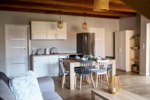a kitchen and dining room with a table and chairs at Kalinowe Wzgórza in Charzykowy