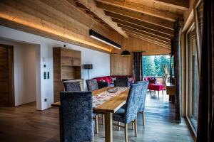 a dining room with a wooden table and chairs at Gästehaus Oben am Berg in Balderschwang