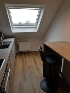a kitchen with a skylight and a desk with a chair at Wolke 7 in Hattingen
