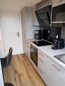 a kitchen with a sink and a stove top oven at Wolke 7 in Hattingen