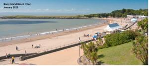 a beach with a large group of people on it at FREE DOG STAY - LARGE APARTMENT - FREE PUBLIC PARKING BEDROOM TV, WALK in SHOWER - FULL Kitchen - NETFLIX - Super Fast WiFi - DVD's-Welcome Tray - No Deposits - Just Meters from Gavin n Stacey Film House in Barry