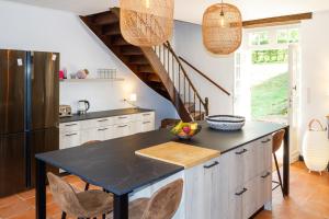 a kitchen with a table and a refrigerator at DordogneView in Calès +22 photos