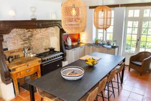 a kitchen with a table with a bowl of fruit on it at DordogneView in Calès