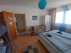 a bedroom with a bed and a crib in it at Ferienwohnung Nordsee mit E-Bike Verleih in Wilhelmshaven