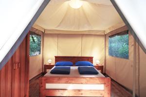 a bedroom with a bed in a tent at Camping Porto Sosàlinos in Cala Liberotto