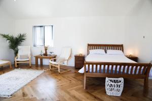 a bedroom with a bed and two chairs and a table at Mortham in Saint Merryn