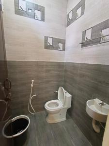 a bathroom with a toilet and a sink at JSP VILLA in Yelagiri