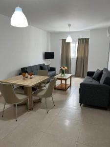 a living room with a table and a couch at Christothea Apartments in Ayia Napa