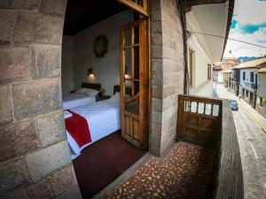 Postel nebo postele na pokoji v ubytování Casona Santa Catalina Cusco