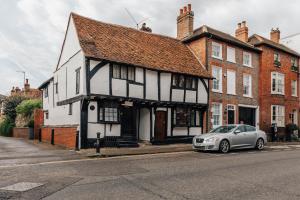 ein weißes Auto, das vor einem Gebäude geparkt ist in der Unterkunft 1400 Cottage An enchanting unique stay in Henley on Thames