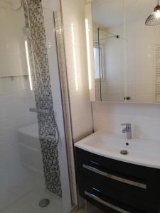 a bathroom with a sink and a shower at Les calanques in Cavalaire-sur-Mer