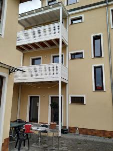 a building with a balcony with tables and chairs at Mehrfamilien Haus in Schkeuditz