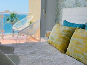 a bedroom with a bed with two pillows on it at Avenida Sudamerica in Roquetas de Mar