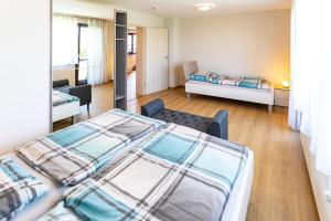 a bedroom with two beds and a living room at Pferdehof Bischof in Wertheim