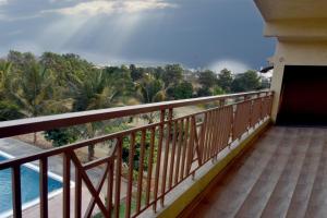 a balcony with a view of the beach and the ocean at Kalwars Millennials Park in Karjat