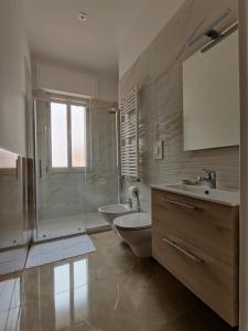 a bathroom with a sink and a toilet and a shower at viLAvì Casa Vacanze in Polignano a Mare