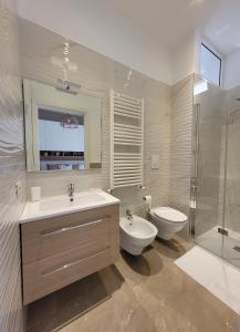 a bathroom with a sink and a toilet and a shower at viLAvì Casa Vacanze in Polignano a Mare