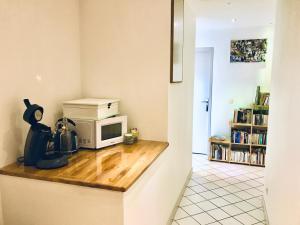 a kitchen with a counter top with a microwave at Chambres à la Campagne in Moirans