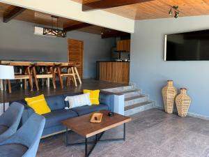a living room with a blue couch and a table at El Refugio in Ensenada