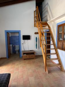 a staircase in a room with a toilet and a television at Can Joan Barber, 2 in La Mola
