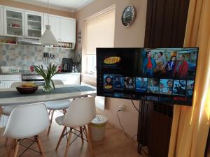 a kitchen with a large flat screen tv on the wall at GreenHouse s bazenom in Otruševec