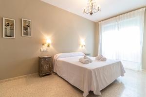 sypialnia z łóżkiem i dwoma ręcznikami na nim w obiekcie Allo Apartments Europa I Parking Piscina Padel 3 Habitaciones w mieście Jerez de la Frontera
