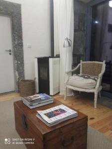 a living room with a coffee table and a chair at Casa da Ribeirinha in Ribeirinha