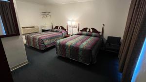 a hotel room with two beds in a room at Four Oaks Lodging in Smithfield